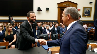 Facebook Head of Global Policy Development Matt Perault, left, shakes hands with Rep. David Cicilline, D-R.I., chair of the House Judiciary antitrust subcommittee, before testifying at a hearing.