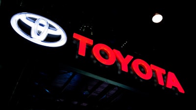 In this Feb. 7, 2018, file photo the logo of Toyota is displayed at the Auto Expo in Greater Noida, near New Delhi, India. Toyota said Wednesday, July 10, 2019, that it will scrap plans to build the Corolla compact car at a new factory under construction in Alabama. Instead it will build a new unspecified SUV at the plant it’s building with Mazda in Huntsville.