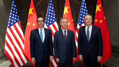 Chinese Vice Premier Liu He, center, poses with U.S. Trade Representative Robert Lighthizer, right, and Treasury Secretary Steven Mnuchin pose for photos before holding talks at the Xijiao Conference Center in Shanghai Wednesday, July 31, 2019.