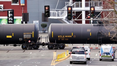 - In this Feb. 13, 2018, file photo, automobile traffic waits at a train crossing as train cars that carry oil are pulled through downtown Seattle. Attorneys general for North Dakota and Montana have petitioned the Trump administration Wednesday, July 17, 2019, to overrule a Washington state law that imposes safety restrictions on oil shipped by rail from the Northern Plains.