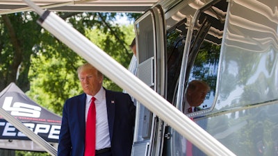 President Donald Trump steps out of an Airstream trailer from Ohio, during a Made in America showcase on the South Lawn of the White House, Monday, July 15, 2019, in Washington.