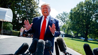 President Donald Trump talks to reporters on the South Lawn of the White House before departing for his Bedminster, N.J. golf club, Friday, July 5, 2019, in Washington.