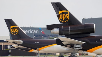 In this June 24, 2019, photo workers prepare to unload a UPS aircraft after it arrived at Dallas-Fort Worth International Airport in Grapevine, Texas. United Parcel Service Inc. announced that starting Jan. 1 it will offer pickup and delivery services seven days a week, adding service on Sundays.
