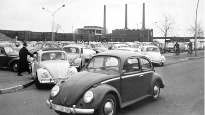 In this April 27, 1966 file photo, Volkswagen workers drive their Beetle cars from the parking lot on their way home at the end of a days work at the world's largest single auto plant, the Volkswagen factory (seen in background) in Wolfsburg, Germany. Volkswagen is halting production of the last version of its Beetle model in July 2019 at its plant in Puebla, Mexico, the end of the road for a vehicle that has symbolized many things over a history spanning eight decades since 1938.