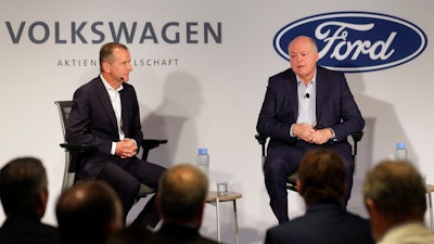 Ford CEO Jim Hackett, right, and Volkswagen CEO Herbert Diess participate in a news conference in New York, Friday, July 12, 2019. Volkswagen will sink $2.6 billion into a Pittsburgh autonomous vehicle company that's mostly owned by Ford as part of a broader partnership on electric and self-driving vehicles, the companies confirmed Friday.