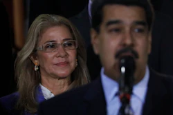 In this file photo, first lady Cilia Flores stands behind her husband, Venezuela's President Nicolas Maduro during a press conference.