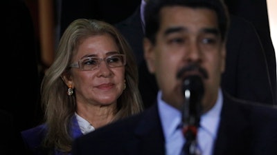 In this file photo, first lady Cilia Flores stands behind her husband, Venezuela's President Nicolas Maduro during a press conference.