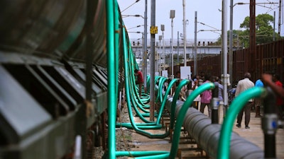 In this Wednesday, July 17, 2019, photo, hose-pipes are used to fill train wagons with drinking water piped in from the Mettur dam on the Cauvery River, at Jolarpet railway station, about 216 kilometers (135 miles) from Chennai in Southern Indian state of Tamil Nadu. On its daily sojourn, the 50-tank train carries two and a half million liters of drinking water, a small but critical source for Chennai’s water board, which is employing an army of trucks to deliver 500 million liters of water a day since desiccated reservoirs and fast-diminishing groundwater forced the city to ration public tap water to millions of users for months.