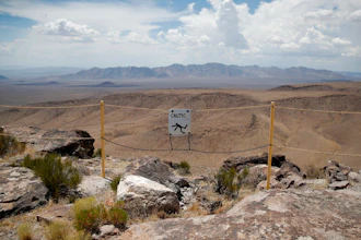 In this July 14, 2018, file photo, a sign warns of a falling danger on the crest of Yucca Mountain during a congressional tour near Mercury, Nev. Nevada's governor and congressional delegation say recent earthquakes should make the U.S. Energy Department look again at seismic risks at a site eyed as the place to bury the nation's nuclear waste, Wednesday, July 17, 2019.