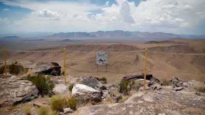 In this July 14, 2018, file photo, a sign warns of a falling danger on the crest of Yucca Mountain during a congressional tour near Mercury, Nev. Nevada's governor and congressional delegation say recent earthquakes should make the U.S. Energy Department look again at seismic risks at a site eyed as the place to bury the nation's nuclear waste, Wednesday, July 17, 2019.