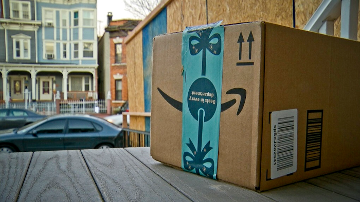 This Dec. 11, 2018 file photo shows an Amazon package containing a GPS tracker on the porch of a Jersey City, N.J. residence after its delivery. News of an alleged Amazon theft ring involving contract delivery drivers is unlikely to make a dent in the online shopping giant’s massive business. But it may make people more wary of letting deliveries into their house when they aren’t there, a nascent project from both Amazon and Walmart.