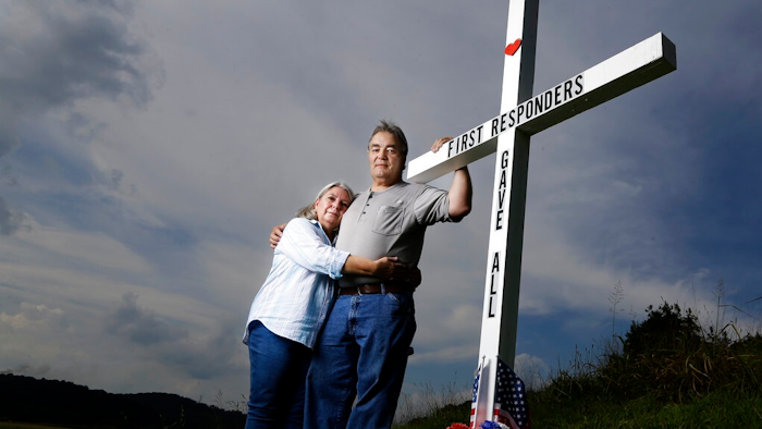 In this Aug. 6, 2019, photo, Ansol and Janie Clark pose at a memorial Ansol Clark constructed near the Kingston Fossil Plant in Kingston, Tenn. The Tennessee Valley Authority was responsible for a massive coal ash spill at the plant in 2008 that covered a community and fouled rivers. The couple says the memorial is for the workers who have come down with illnesses, some fatal, including cancers of the lung, brain, blood and skin and chronic obstructive pulmonary disease. Ansol Clark drove a fuel truck for four years at the cleanup site, and now suffers from a rare blood cancer.