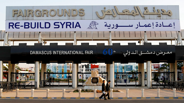 In this Oct. 2, 2018 file photo, Chinese visitors arrive to the opening of the Syria rebuilding exhibition, in Damascus, Syria. The U.S. Embassy in Syria on Wednesday, Aug. 28, 2019 posted a statement on Twitter that warned businesses from outside Syria against participating in an annual trade fare to be held in Damascus. It said anyone doing business with President Bashar Assad's government will expose themselves to the possibility of U.S. sanctions.