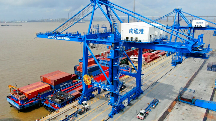 In this July 18, 2019, file photo, shipping containers are loaded onto a cargo ship at a port in Nantong in eastern China's Jiangsu province. Beijing appealed to Washington on Wednesday, Aug. 21, to 'meet China halfway' and end a tariff war after President Donald Trump said Americans might need to endure economic pain to achieve longer-term benefits.