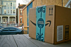 This Dec. 11, 2018 file photo shows an Amazon package containing a GPS tracker on the porch of a Jersey City, N.J. residence after its delivery. News of an alleged Amazon theft ring involving contract delivery drivers is unlikely to make a dent in the online shopping giant’s massive business. But it may make people more wary of letting deliveries into their house when they aren’t there, a nascent project from both Amazon and Walmart.