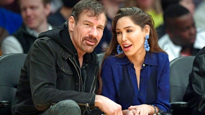 This March 6, 2019, file photo shows Henry Nicholas III, left, and Ashley Fargo during the second half of an NBA basketball game between the Los Angeles Lakers and the Denver Nuggets in Los Angeles. Attorneys for Nicholas and Fargo told a judge in Las Vegas on Wednesday, July 31, 2019, they'll take a plea deal that will spare them prison time in a Las Vegas Strip hotel room drug case.