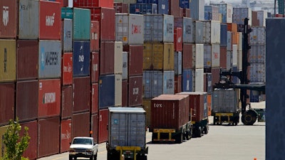 In this July 22, 2019, photo stacked containers wait to be loaded on to trucks at the Port of Oakland in Oakland, Calif. On Friday, Aug. 2, the Commerce Department reports on the U.S. trade gap for June.