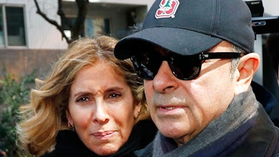 This March, 2019, file photo shows former Nissan Chairman Carlos Ghosn, right, and his wife Carole in Tokyo. The wife of former Nissan Chairman Carlos Ghosn is protesting restrictions on contacting her husband as he awaits trial in Japan on financial misconduct allegations, calling them a human rights violation. Carole Ghosn said Tuesday, Aug. 6, 2019, the family's fifth appeal to gain visitation rights was refused by a Tokyo court without explanation.