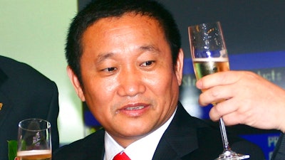 In this May 8, 2009 file photo, Liu Zhongtian, the Chinese billionaire chairman of the China Zhongwang Holdings Limited, celebrates at the company's listing ceremony in the Hong Kong Stock Exchange. Liu has been charged in Los Angeles in a complex scheme to avoid $1.8 billion in aluminum tariffs, U.S. prosecutors said, Wednesday, July 31, 2019. Liu and the aluminum company he previously headed, were charged with conspiracy, wire fraud and money laundering.