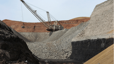 In this file photo, a dragline excavator moves rocks above a coal seam near Decker, Montana.