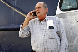 In this Oct. 14, 2014, file photo, Carlos Rafael talks on the phone at Homer's Wharf near his herring boat F/V Voyager in New Bedford, Mass. Rafael was sentenced to prison in 2017 after pleading guilty to evading fishing quotas and smuggling profits overseas. The federal government announced Monday, Aug. 19, 2019, it has settled its civil case against Rafael, a fishing magnate known as The Codfather, saying he will never be allowed to return to U.S. fisheries.