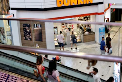 Shoppers ride an escalator inside the Glendale Galleria in Glendale, California.