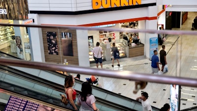 Shoppers ride an escalator inside the Glendale Galleria in Glendale, California.