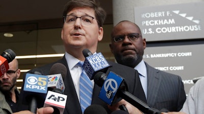 Attorneys Miles Ehrlich, left, and Ismail Ramsey, representing Anthony Levandowski, speak to reporters at a federal courthouse in San Jose, Calif., Tuesday, Aug. 27, 2019. Levandowski, a former Google engineer, was charged Tuesday with stealing closely guarded secrets that he later sold to Uber as the ride-hailing service scrambled to catch up in the high-stakes race to build robotic vehicles.