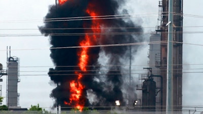 Flames and smoke rise after a fire started at an Exxon Mobil facility, Wednesday, July 31, 2019, in Baytown, Texas.