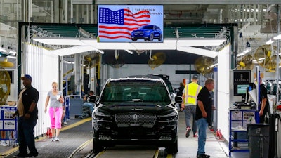 In this June 24, 2019, file photo Ford's employees work on a Lincoln Aviator line at Ford's Chicago Assembly Plant in Chicago's Hegewisch neighborhood. On Thursday, Aug. 15, the Federal Reserve reports on U.S. industrial production for July.