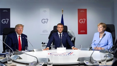 U.S President Donald Trump, French President Emmanuel Macron and German Chancellor Angela Merkel attend a working session during the G7 summit at Casino in Biarritz, southwestern France, Monday Aug.26 2019. G-7 leaders are wrapping up a summit dominated by tensions over U.S. trade policies and a surprise visit by Iran's top diplomat.
