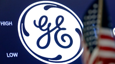 In this June 26, 2018, file photo the General Electric logo appears above a trading post on the floor of the New York Stock Exchange. General Electric’s stock is tanking after a report which claims the company has been misleading investors. Investigator Harry Markopolos accused GE Thursday, Aug. 15, of engaging in accounting fraud worth $38 billion. He said GE is heading for bankruptcy and is hiding $29 billion in long-term care losses.