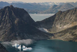 Icebergs are photographed from the window of an airplane carrying NASA Scientists to eastern Greenland.