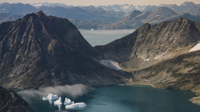 Icebergs are photographed from the window of an airplane carrying NASA Scientists to eastern Greenland.