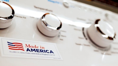In this May 9, 2019, file photo a General Electric washing machine with a label advertising it was made in America is displayed in retail stores in Cranberry Township, Pa. China has announced it will raise tariffs on $75 billion of U.S. products in retaliation for President Donald Trump's planned Sept. 1 duty increase in a war over trade and technology policy.