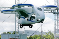 NEC Corp.'s machine with propellers hovers at the company's facility in Abiko near Tokyo, Monday, Aug. 5, 2019. The Japanese electronics maker showed a 'flying car,' a large drone-like machine with four propellers that hovered steadily for about a minute.