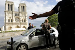 Police officers clear the area around Notre Dame cathedral in Paris, Monday, Aug. 12, 2019. Authorities started clearing the area around Notre Dame ahead of decontamination and cleanup work which will resume on Aug. 19 after new equipment and stricter safety procedures ensure workers are not exposed to unsafe levels of lead following the fire earlier this year.