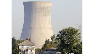This Oct. 5, 2011 file photo shows the cooling tower of the Davis-Besse Nuclear Power Station in Oak Harbor, Ohio. A financial rescue for Ohio's nuclear plants and two coal-fired plants has infuriated environmentalists and conservatives. The plan signed into law it July 23, 2019 by Republican Gov. Mike DeWine calls for giving the state’s two nuclear plants $150 million a year through 2026.
