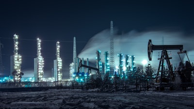 Oil Rigs And Brightly Lit Industrial Site At Night 510477582 4256x2832