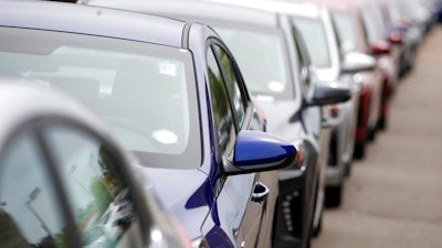 In this May 19, 2019, file photograph, a long line of unsold 2019 sedans sits at a dealership in Littleton, Colo. Alerts from new driver assist systems can be so annoying that some motorists are turning the features off, according to a new survey.