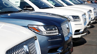 In this July 28, 2019, file photo unsold 2019 Lincoln Navigators sit at a dealership in Englewood, Colo. On Thursday, Aug. 15, the Commerce Department releases U.S. retail sales data for July.