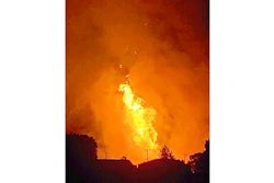 In this Thursday, Aug. 1, 2019 photo provided by Naomi Hayes, a fire burns after an explosion near Junction City, Ky. A regional gas pipeline ruptured early Thursday in Kentucky, causing a massive explosion that killed one person, hospitalized five others, destroyed railroad tracks and forced the evacuation of a nearby mobile home park, authorities said.