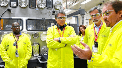In this May 10, 2017, file photo provided by the Los Alamos National Laboratory, U.S. Secretary of Energy Rick Perry, second from left, accompanied by Laboratory Director Charlie McMillan, second from right, learns about capabilities at the Los Alamos Laboratory Plutonium Facility, from Jeff Yarbrough, right, Los Alamos Associate Director for Plutonium Science and Manufacturing, in Los Alamos.