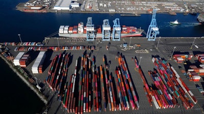 In this March 5, 2019, file photo, cargo containers are staged near cranes at the Port of Tacoma, in Tacoma, Wash. Most economists were already worried that the odds of a recession are rising, and most of the worries stem from the U.S.-China trade war.