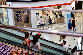 In this Aug. 7, 2019, photo shoppers ride an escalator inside the Glendale Galleria in Glendale, Calif. If a threat of a recession gives you pause when it comes to your personal finances, remember now is a time to prepare, not panic. Financial experts say there a steps you can take now to brace yourself for any downturn ahead.