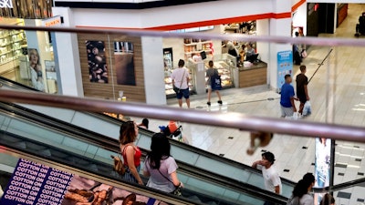 In this Aug. 7, 2019, photo shoppers ride an escalator inside the Glendale Galleria in Glendale, Calif. If a threat of a recession gives you pause when it comes to your personal finances, remember now is a time to prepare, not panic. Financial experts say there a steps you can take now to brace yourself for any downturn ahead.
