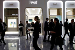 In this March 14, 2019, file photo people attend the opening of a Piaget store during the opening night of The Shops & Restaurants at Hudson Yards in New York. The U.S. job market isn’t quite as strong as originally believed, with revised figures showing that the economy had 501,000 fewer total jobs this March than initially reported. The Labor Department says that nearly two-thirds of the downward revision came from the retail and leisure and hospitality sectors, the industries most associated with consumer spending.