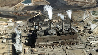 This Nov. 9, 2009, file photo shows the coal-fired San Juan Generating Station near Farmington, N.M. The New Mexico Public Regulation Commission is considering proposals from Public Service Co. of New Mexico that outline the closure of the power plant and how the utility plans to replace the lost capacity. New Mexico Gov. Michelle Lujan Grisham on Tuesday, Aug. 6, 2019, announced her intention to have lawmakers consider reforms to the regulatory panel during the next legislative session.