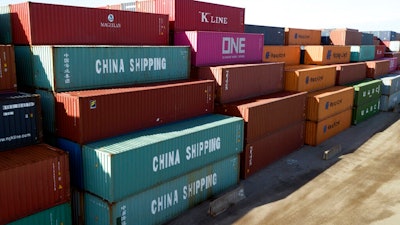 In this May 10, 2019, file photo China Shipping Company and other containers are stacked at the Virginia International's terminal in Portsmouth, Va. A coalition of 161 manufacturers, farmers, retailers, natural gas and oil companies as well as other business groups, has signed a letter asking President Donald Trump to postpone all tariff rate increases on Chinese goods slated to take effect this year. The letter, dated Wednesday, Aug. 28, and organized by Americans for Free Trade Coalition, comes as tariff increases are set to take effect starting this Sunday, followed by further increases Oct. 1 and Dec. 15.