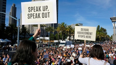 In this Nov. 1, 2018, file photo, Google employees hold up signs during a walkout rally at Harry Bridges Plaza in San Francisco to protest against what they said is the tech company's mishandling of sexual misconduct allegations against executives. Employees at Google, Amazon, Microsoft and elsewhere are increasingly speaking out about military warfare, immigration and the environment, and questioning the effects of their work. Experts say it’s an unprecedented trend of activism in Big Tech.